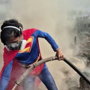 Adolescente se une a la lucha contra los incendios forestales en Indonesia vestido de Superman